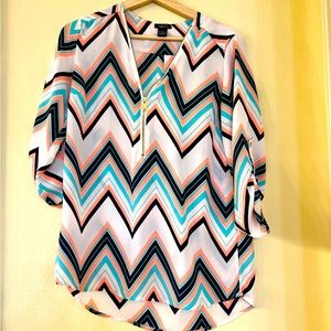Cute light chevron shirt with zip up front. Worn once. Size S